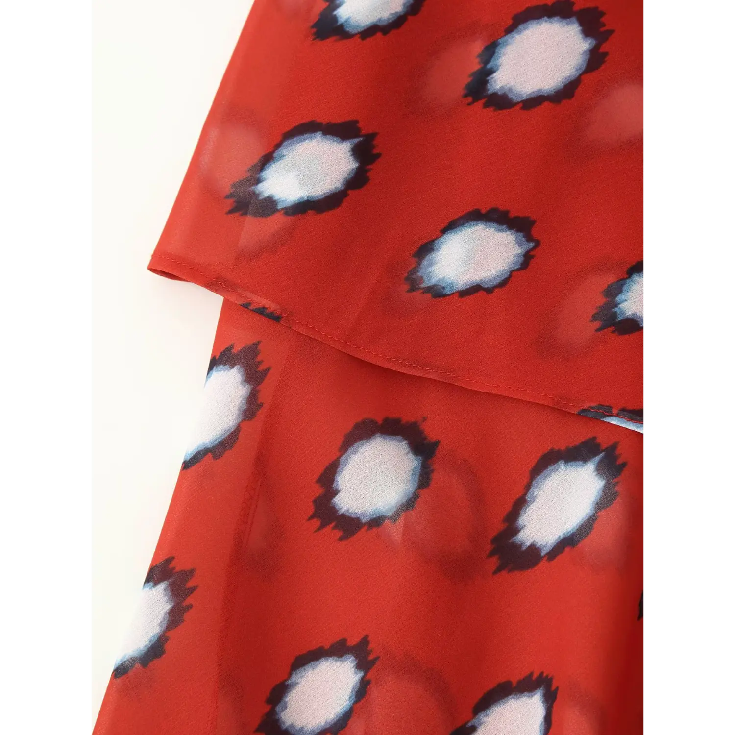 Side tie layered wrap detail of red polka dot chiffon spaghetti strap dress