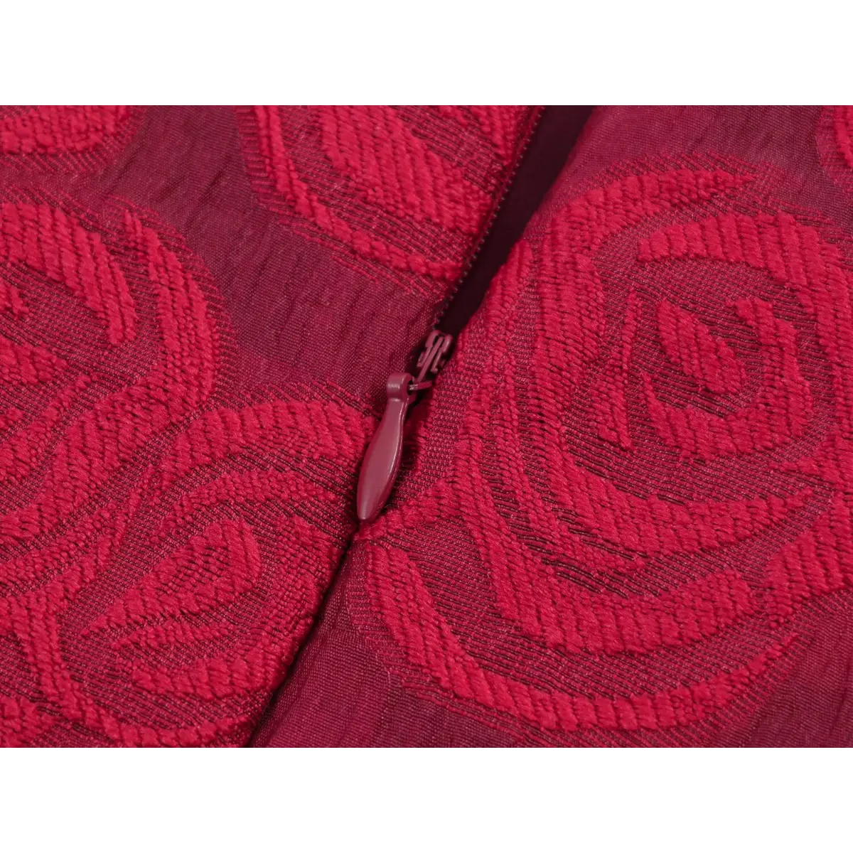 Close-up of the center-back zipper closure on a red rose brocade sleeveless dress.