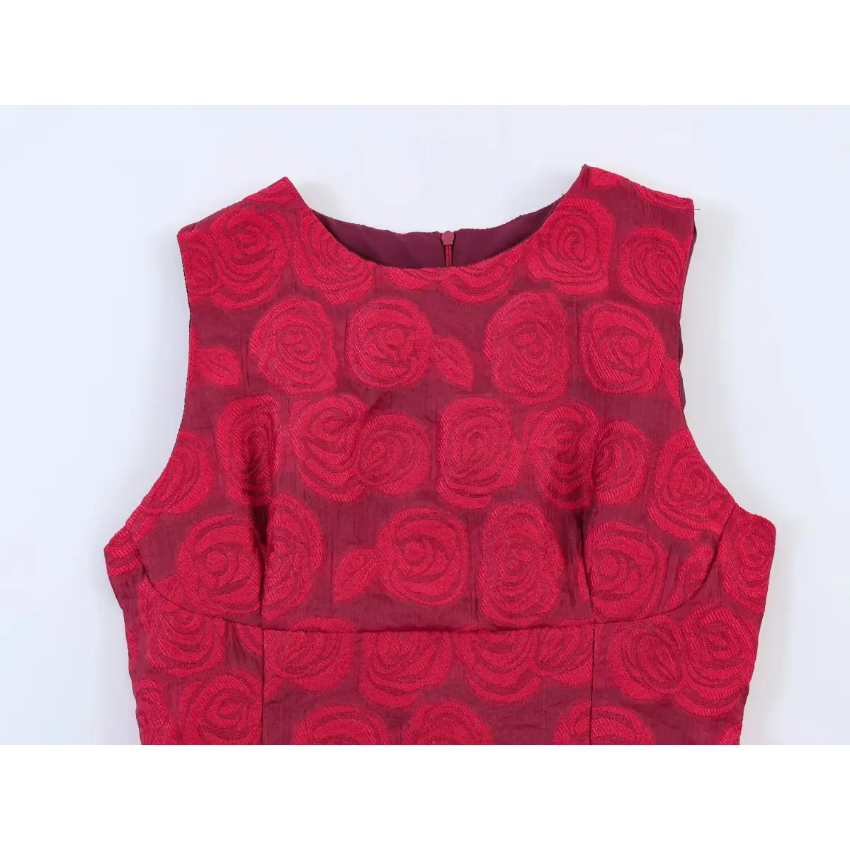 Front view of a red rose brocade sleeveless dress, highlighting the round neckline and center-back zipper closure.