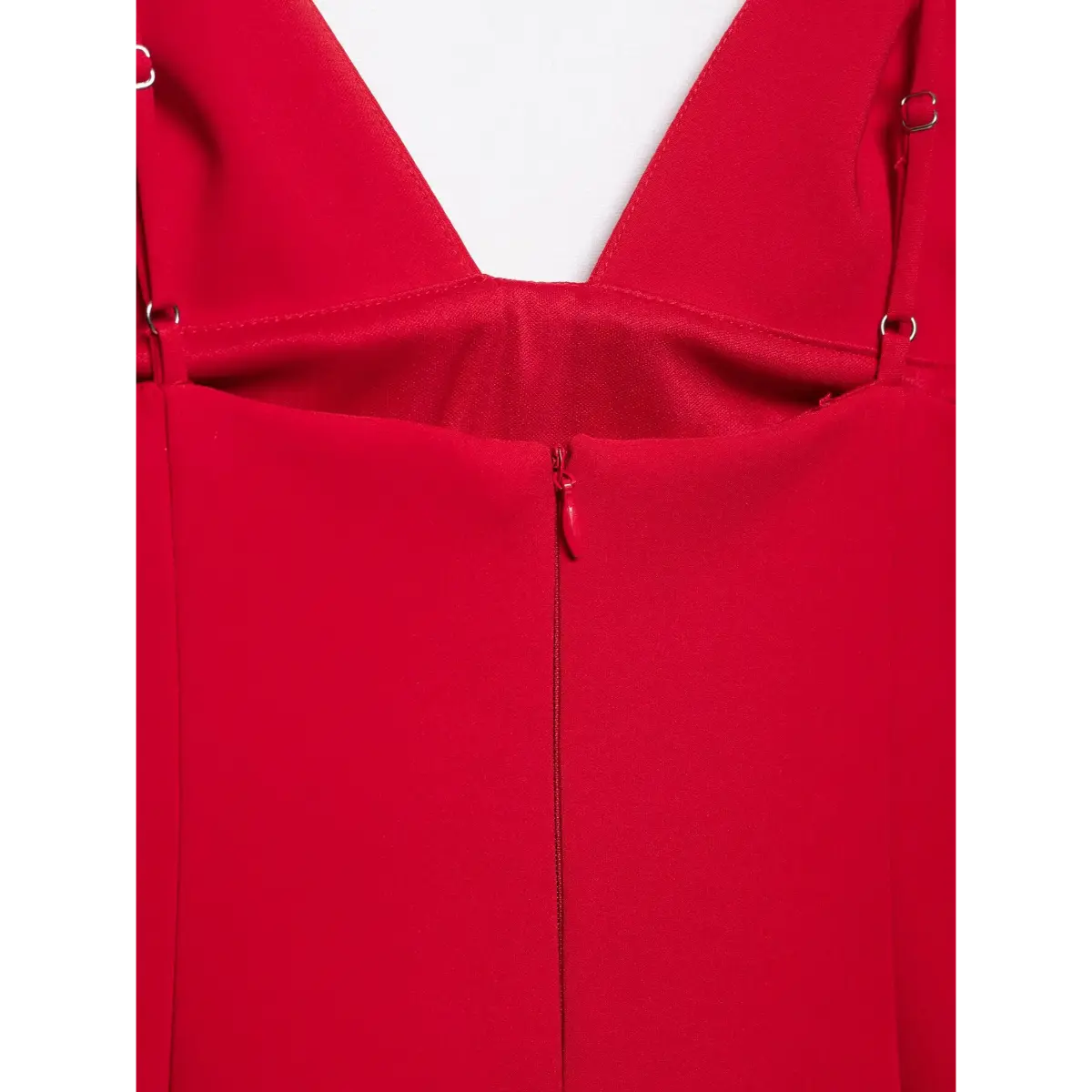 Close-up of the dress's center back zipper, with a matching red pull tab.