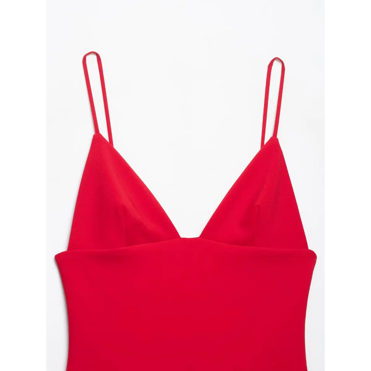 Close-up of the dress's front, showing the deep V-neckline and double spaghetti straps.