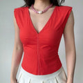 Female model wearing red fitted V-neck ruffle cap sleeve tie back poplin top