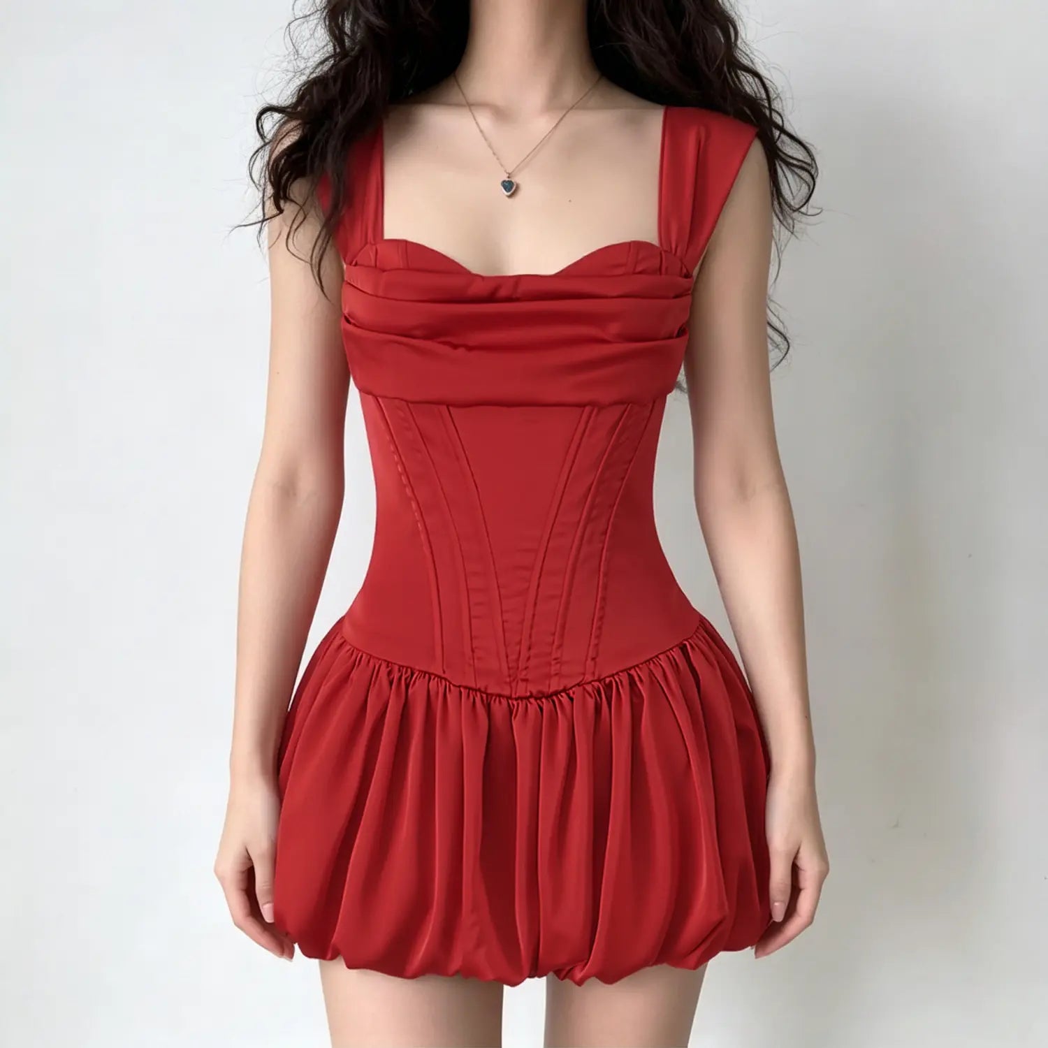 Model wearing vibrant red satin corset mini dress with draped cowl bust structured boned waist and balloon bubble mini skirt