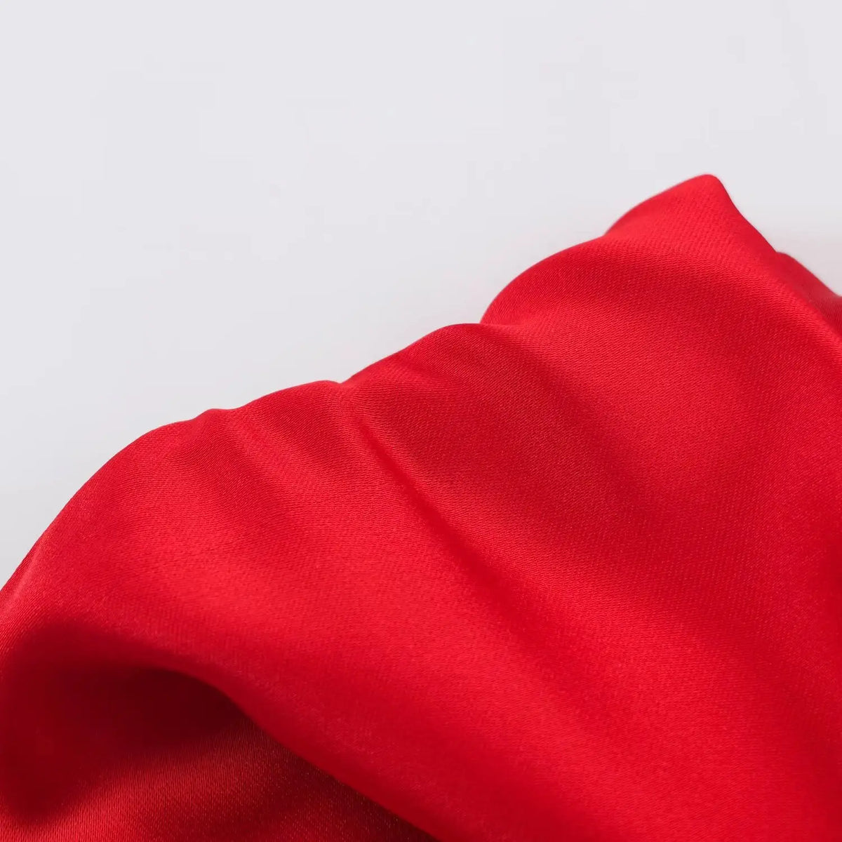 Close-up of draped red satin fabric folds