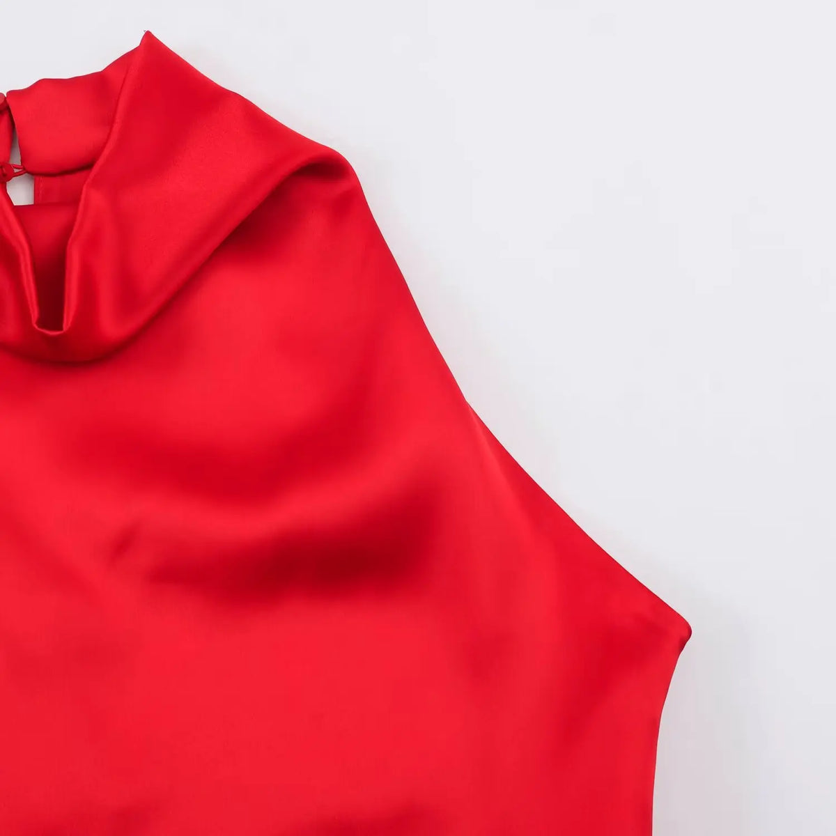 Close-up of draped cowl neckline angle on red satin dress