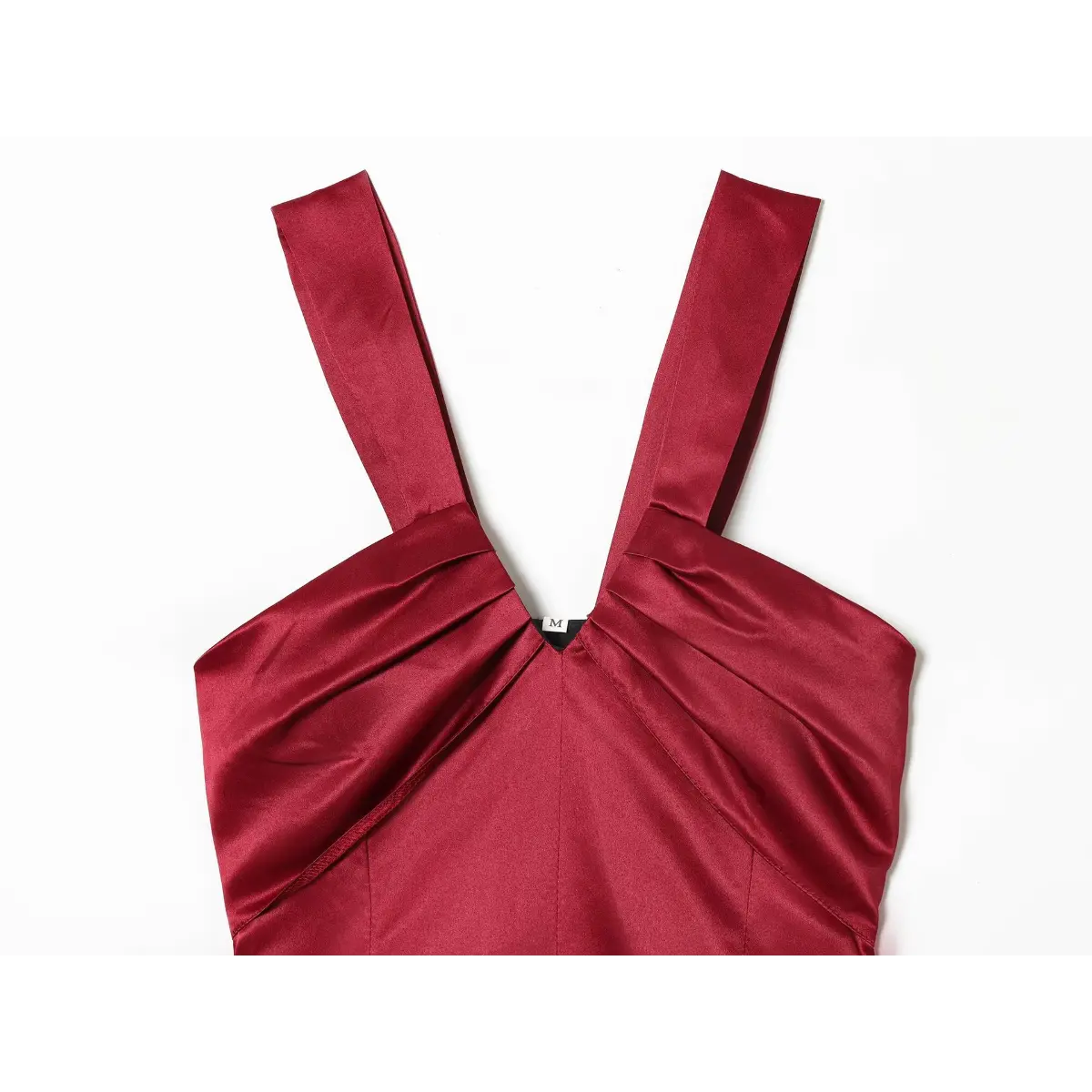Close-up view of the wide straps and gathered V-neck on a red satin mini dress, showing the pleated fabric construction.