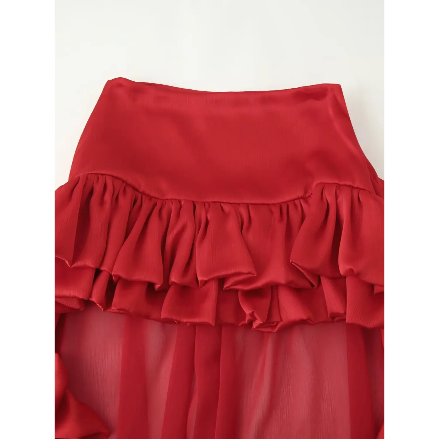 Close up shot of red textured satin tier ruffle waistband on sheer chiffon maxi skirt