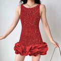 Lifestyle wearing shot of red sequin party dress with ruffled hem, paired with accessories