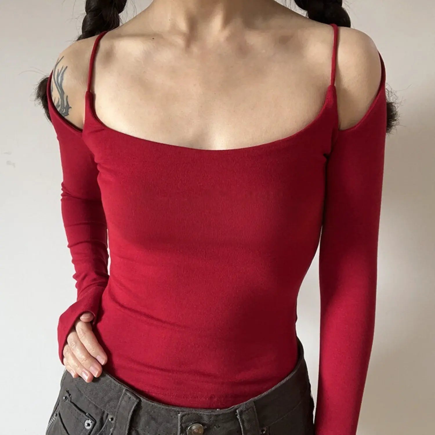 Red spaghetti strap off shoulder long sleeve top half body indoor shot, stretch knit slim cropped square cold shoulder bright retro hot girl vibe outfit