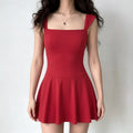 Full-body shot of a woman wearing a bright red sleeveless fit-and-flare mini dress with a square neckline.