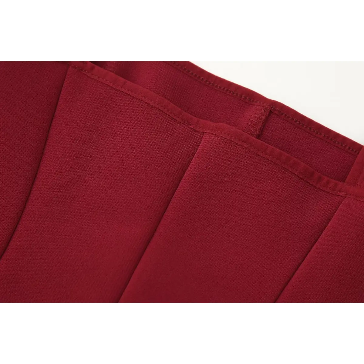 Close-up of the back neckline on the red bustier cami top, showing the reinforced strap attachment and vertical seams