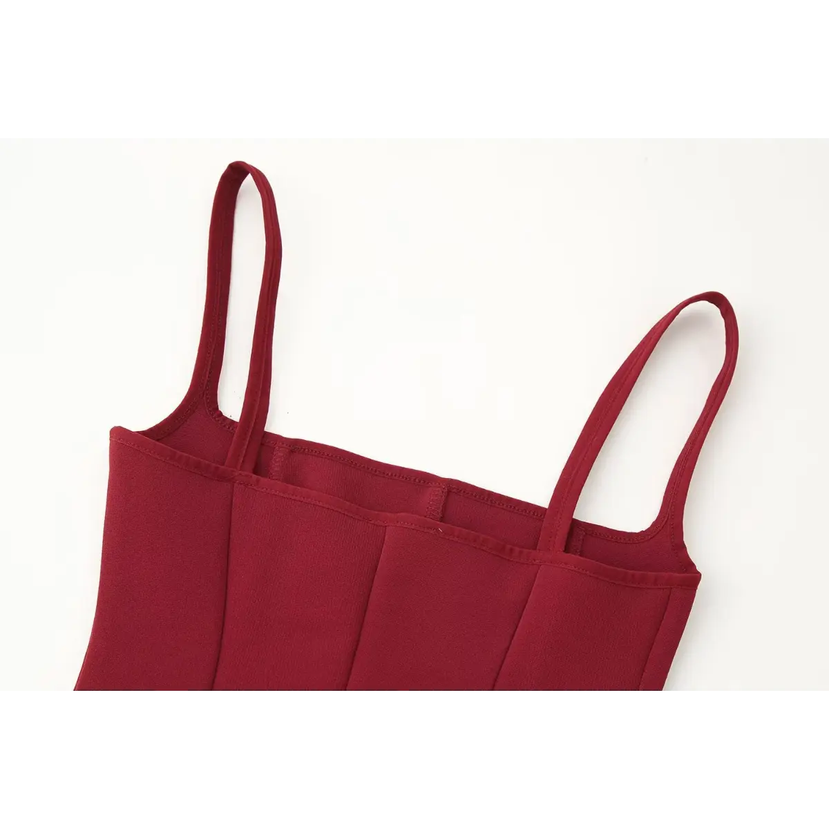 Front view of the red bustier cami top, showing the straight neckline, thin spaghetti straps, and structured vertical boning seams