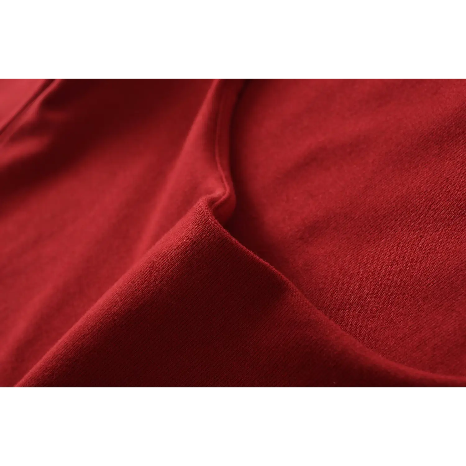 Red off shoulder top stretch knit fabric macro flat close-up, soft high stretch fine smooth knit breathable fabric white background shot