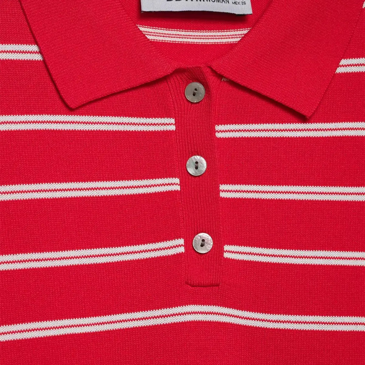 Close-up of the button placket on the red and white striped knit polo shirt, showing the mother-of-pearl buttons and ribbed collar