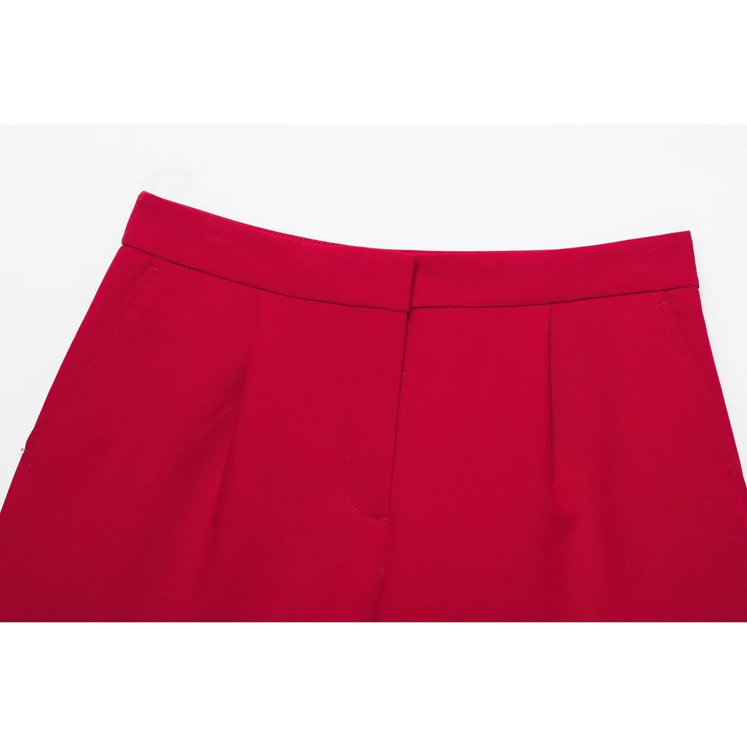 Close‑up front waist detail of red suit shorts, high waistband, front pleats, fly closure, side pocket stitching, white background