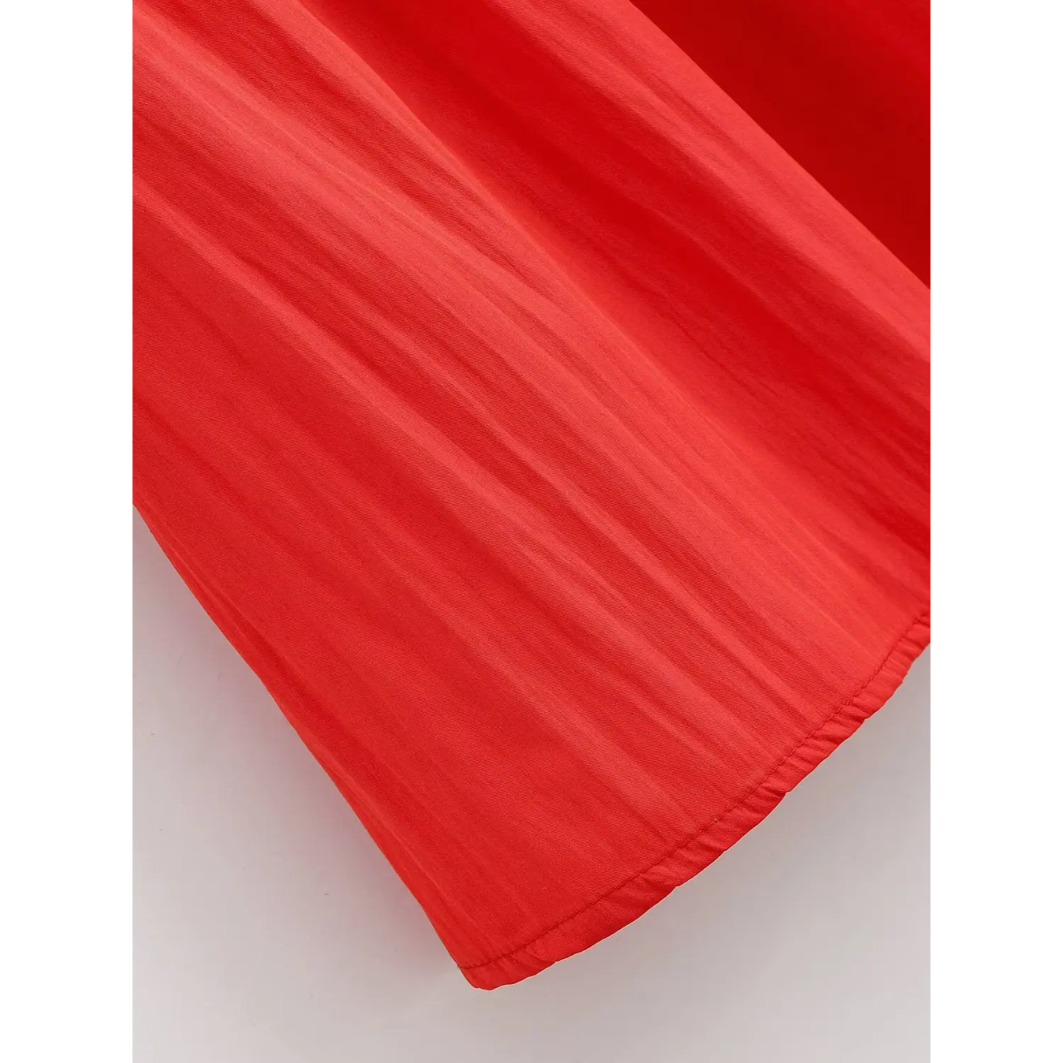 Bottom flared skirt hem closeup, narrow folded clean finished stitching, flowy natural drape lightweight red fabric