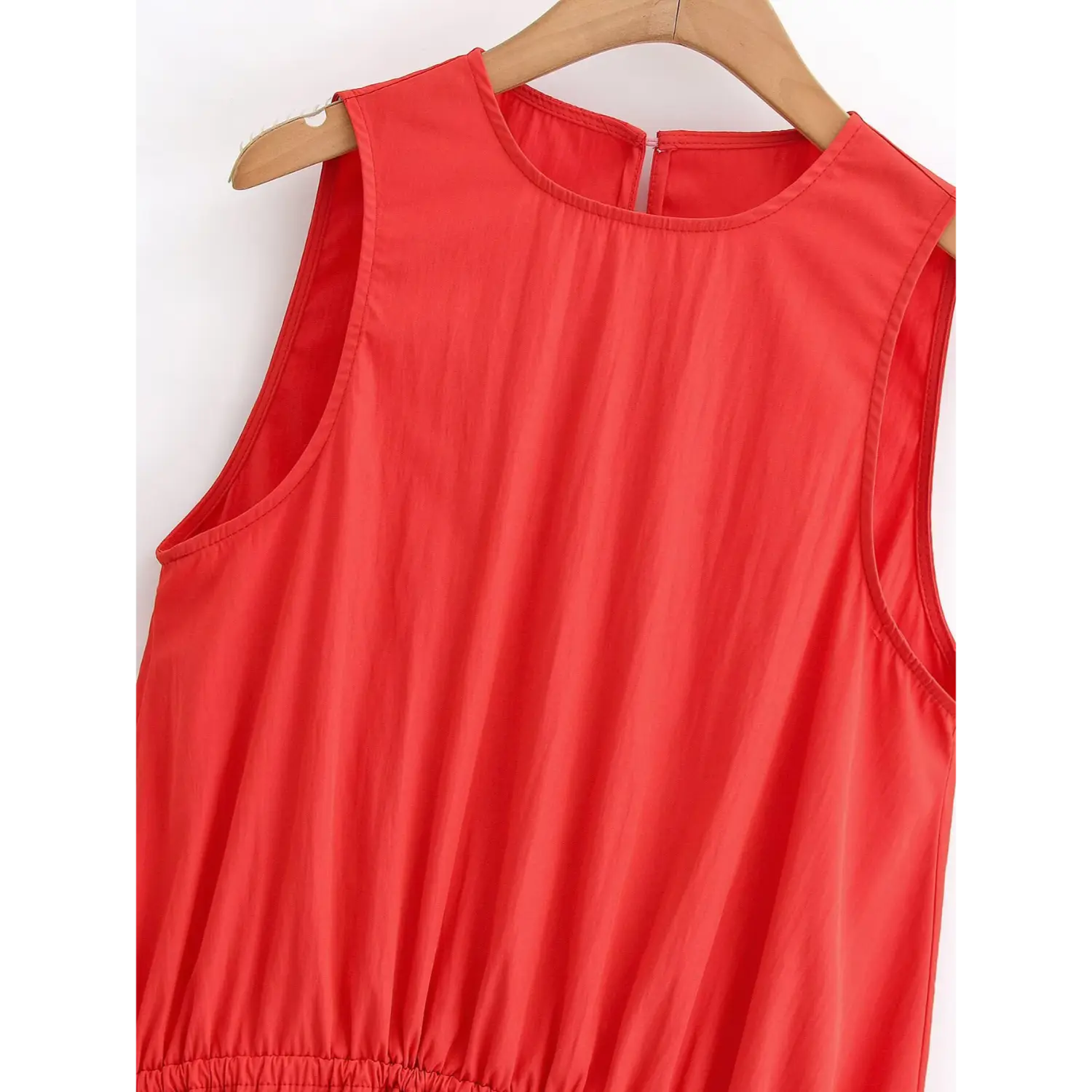 Closeup crew neck and sleeveless armhole binding stitching, smooth bright red lightweight fabric, back keyhole split detail at rear neck