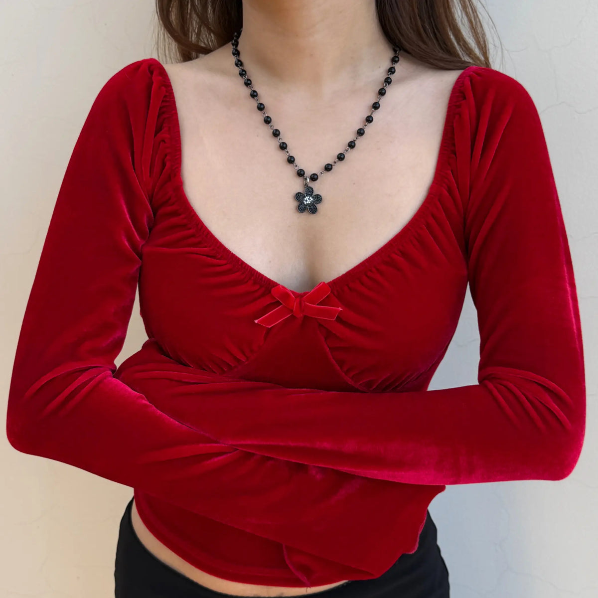 Close-up of red velvet sweetheart neckline and bow