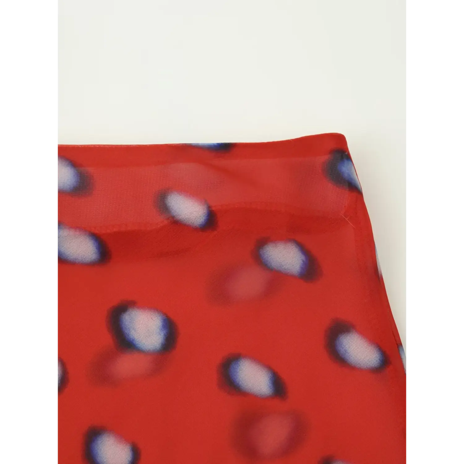 macro texture shot solid red waistband chiffon with blurred blue oval dots lightweight sheer fabric weave