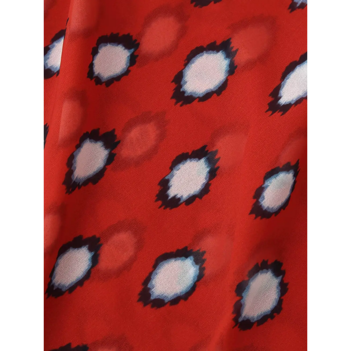 Macro close‑up of red fabric with abstract dot pattern
