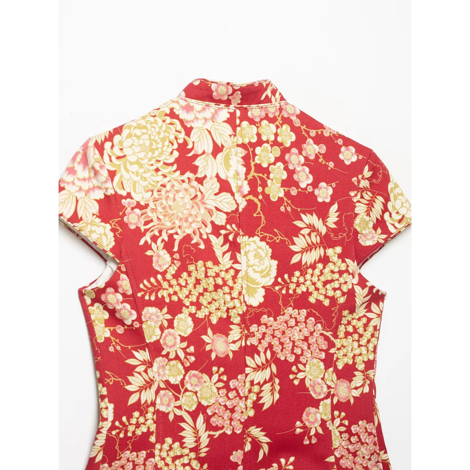 Flat lay upper back detail of red chinese floral cap‑sleeve jacket, showing mandarin stand collar, central back seam and peony‑plum blossom print