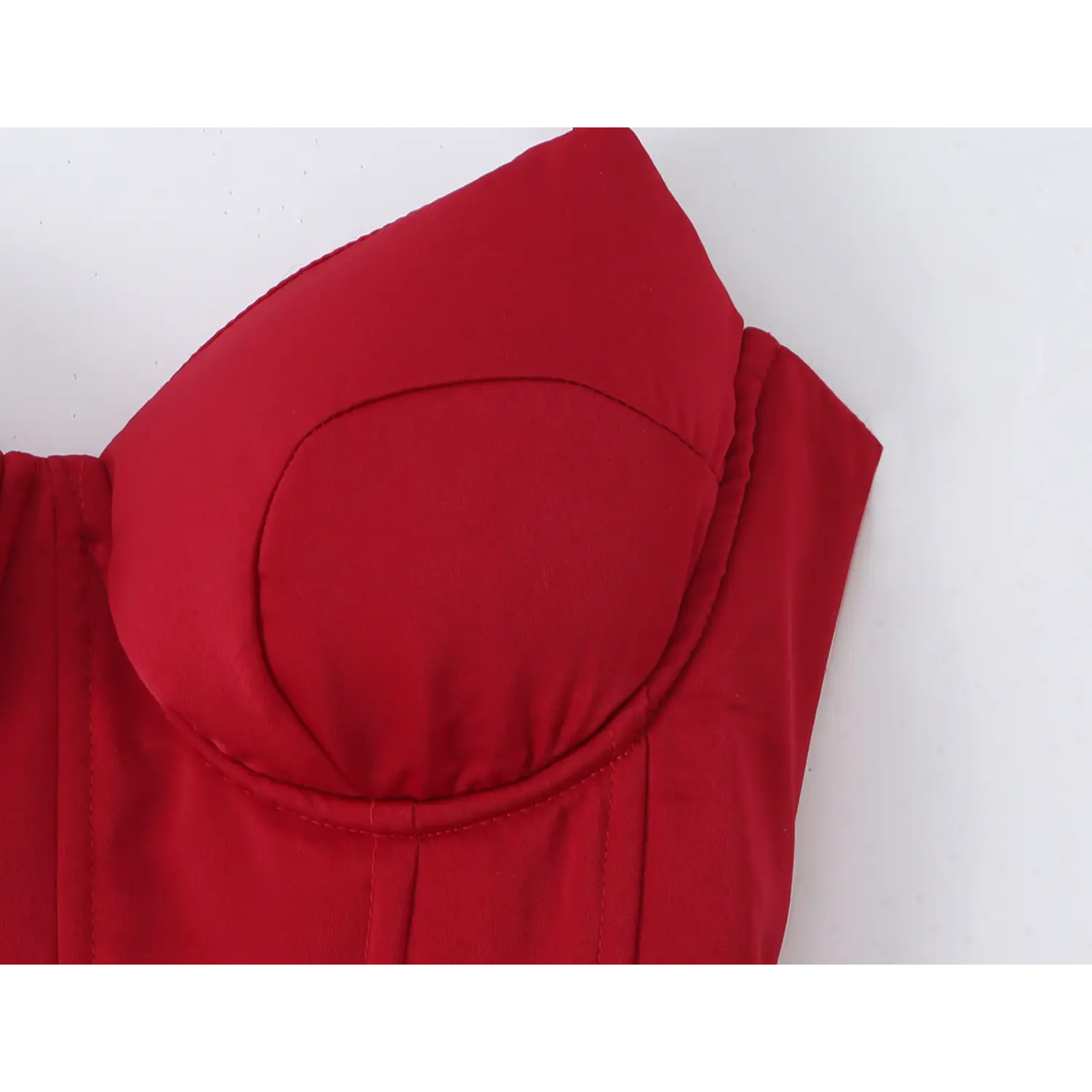 Close‑up of structured bust cup detail on red corset dress