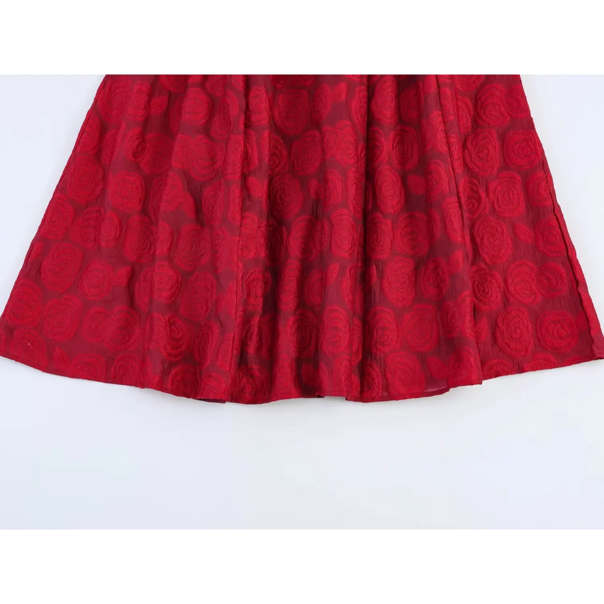 Close‑up of pleated flared skirt with jacquard texture