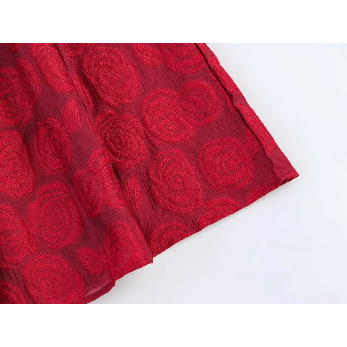 Close‑up of flared skirt hem with embossed jacquard pattern