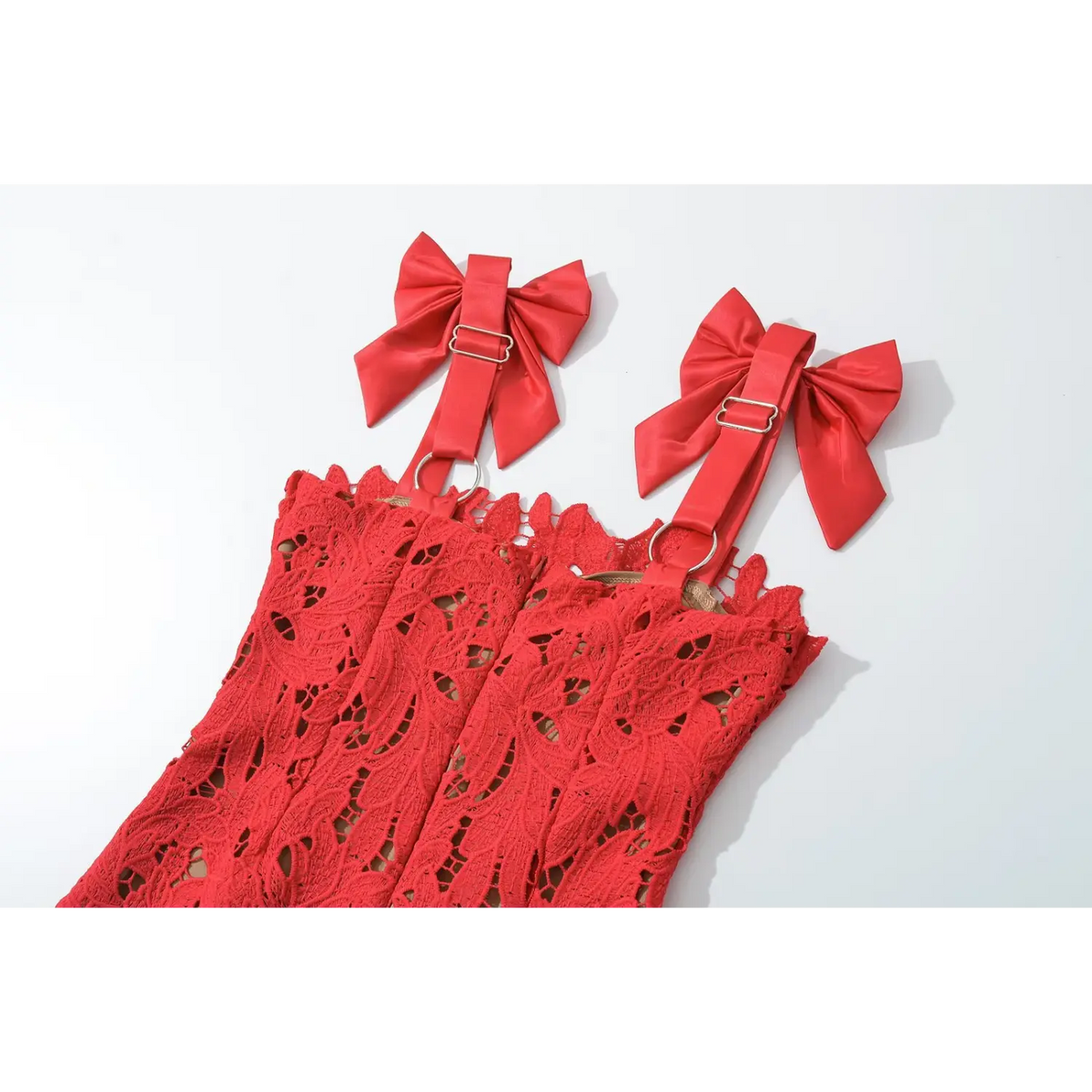 Partial close‑up of bust area and satin bow shoulder straps