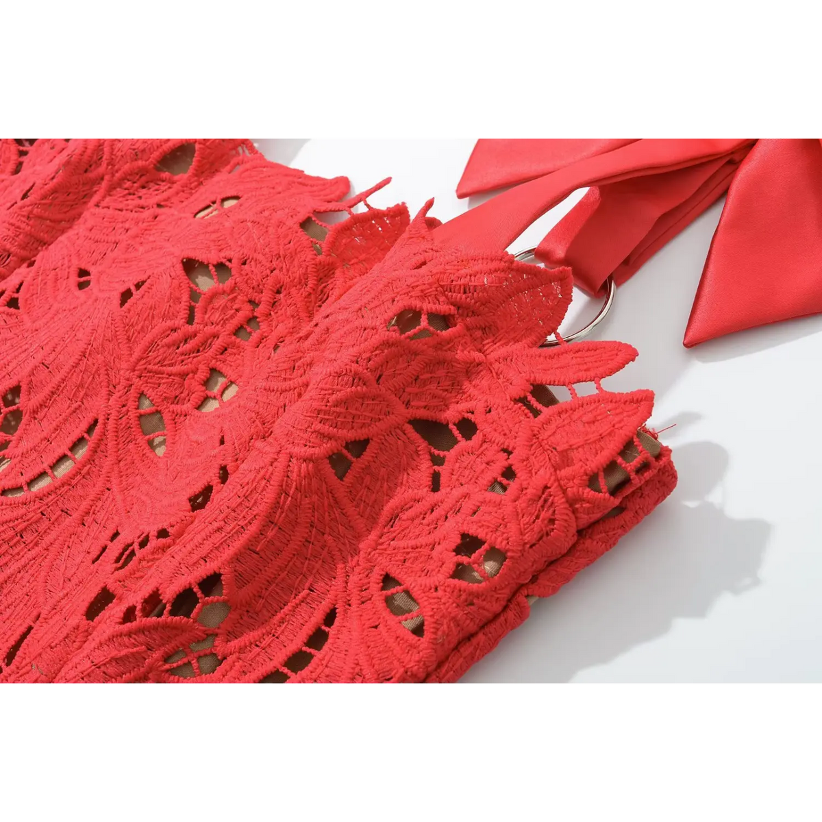 Close‑up of hollow floral red lace fabric texture