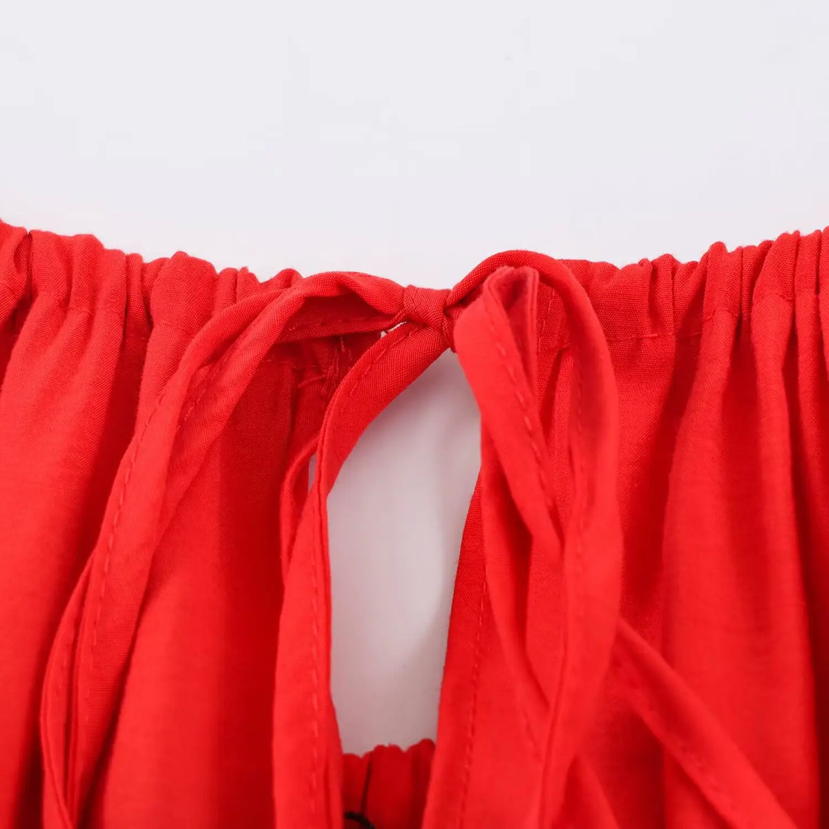 Macro close‑up of back keyhole tie‑opening detail