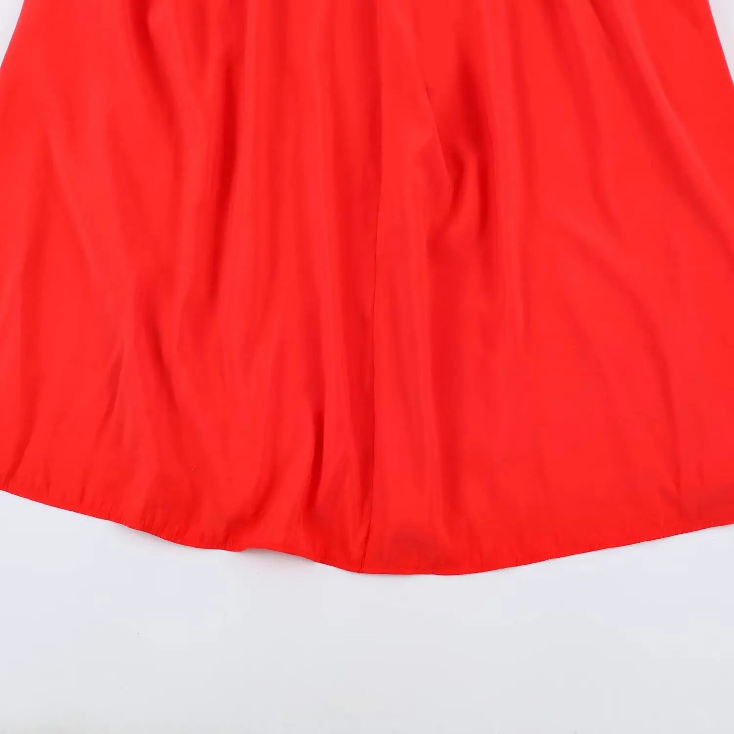 Partial flat view of flowy loose skirt finished hem