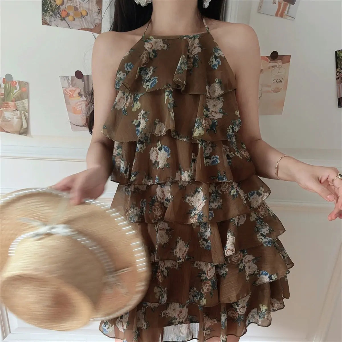 Indoor casual lifestyle look of coffee tone floral print halter layered mini dress, flowy chiffon fabric and loose A-line short skirt.
