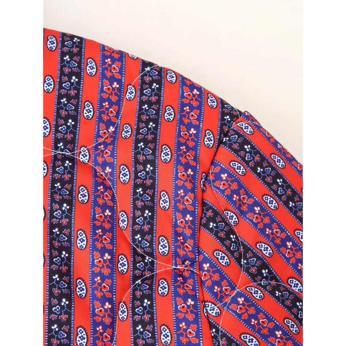 Close-up of quilted stitching on red stripe fabric