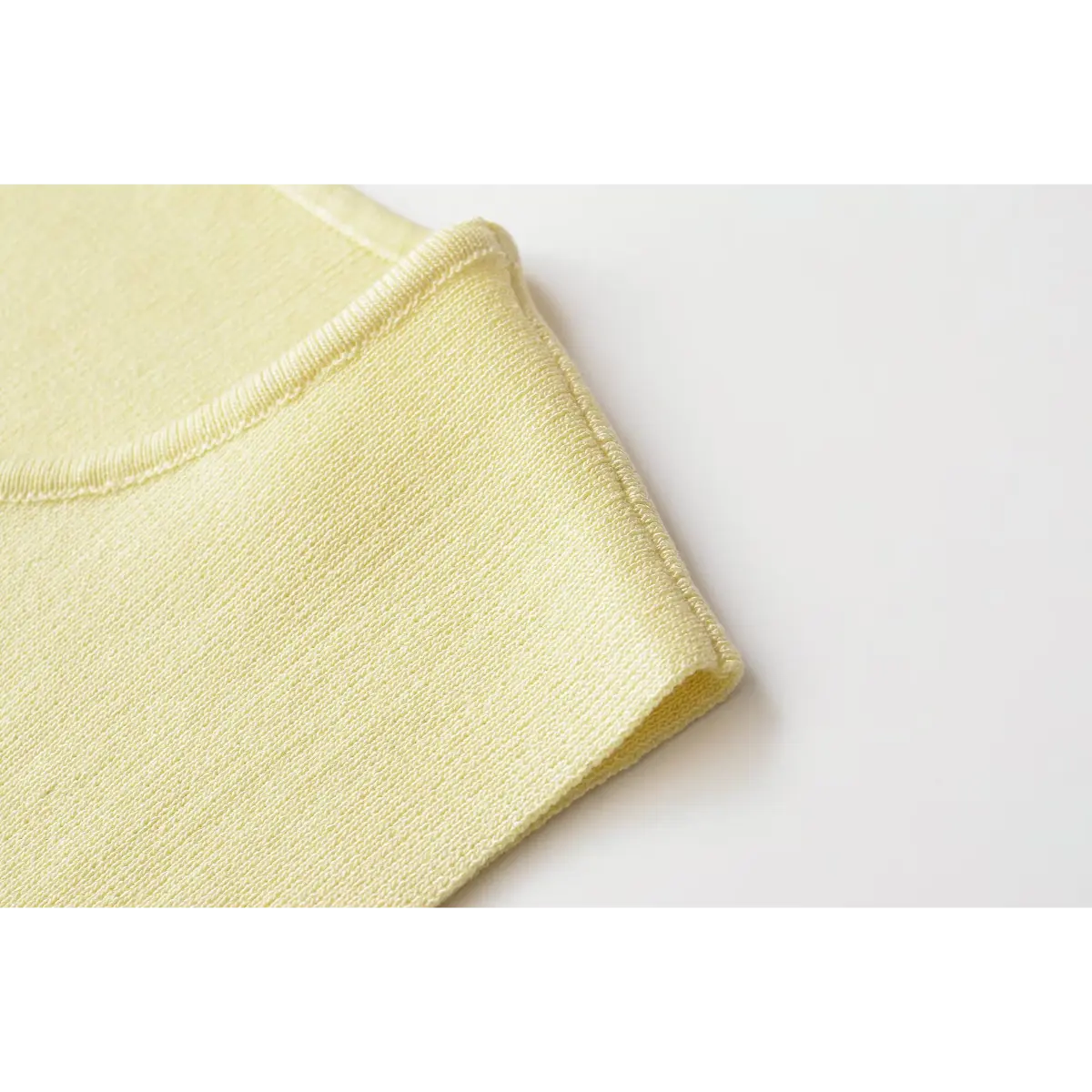 Bottom rib hem neat stitching detail of yellow knit vest