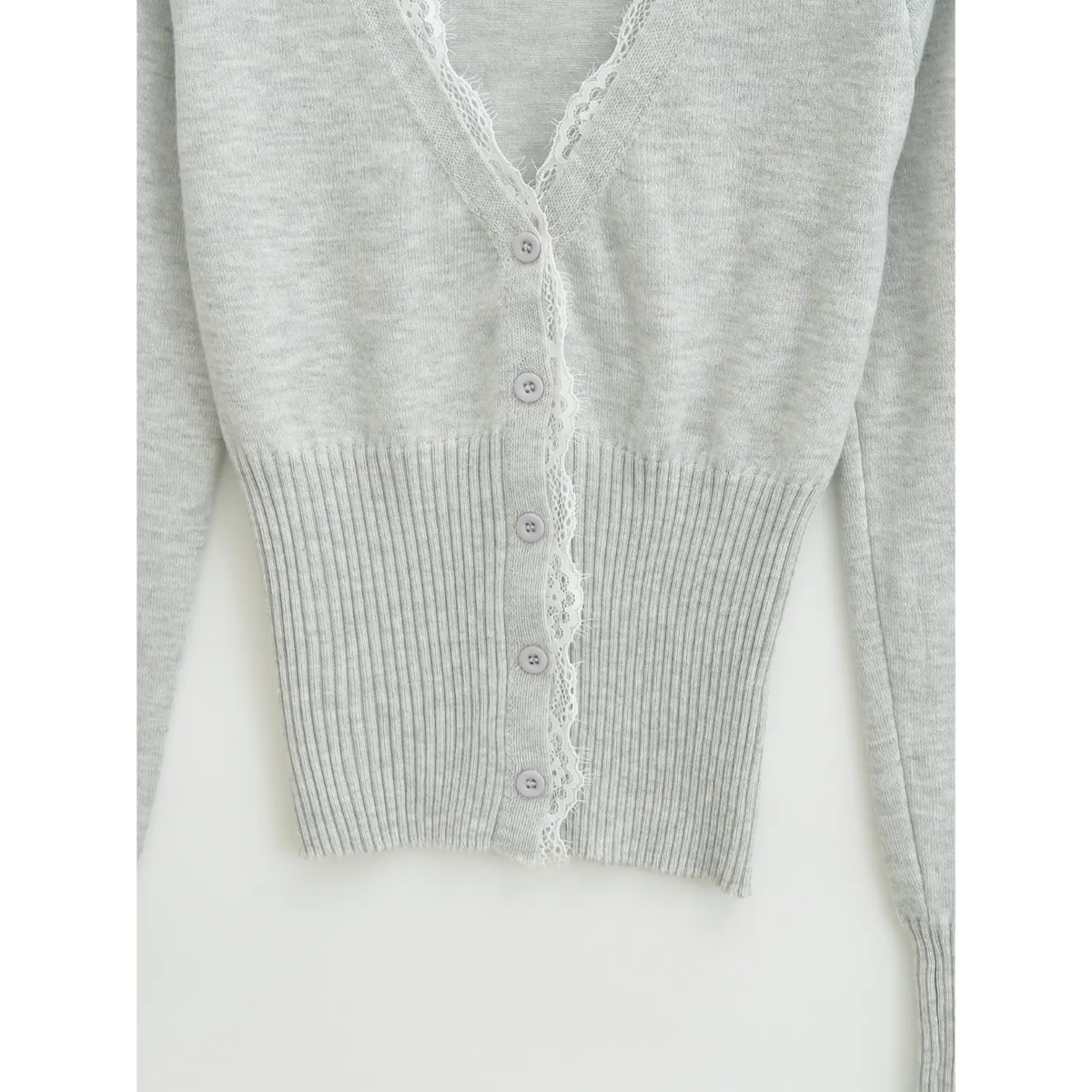 Waist part detail of light grey knit cardigan, wide ribbed hem for slim cropped silhouette