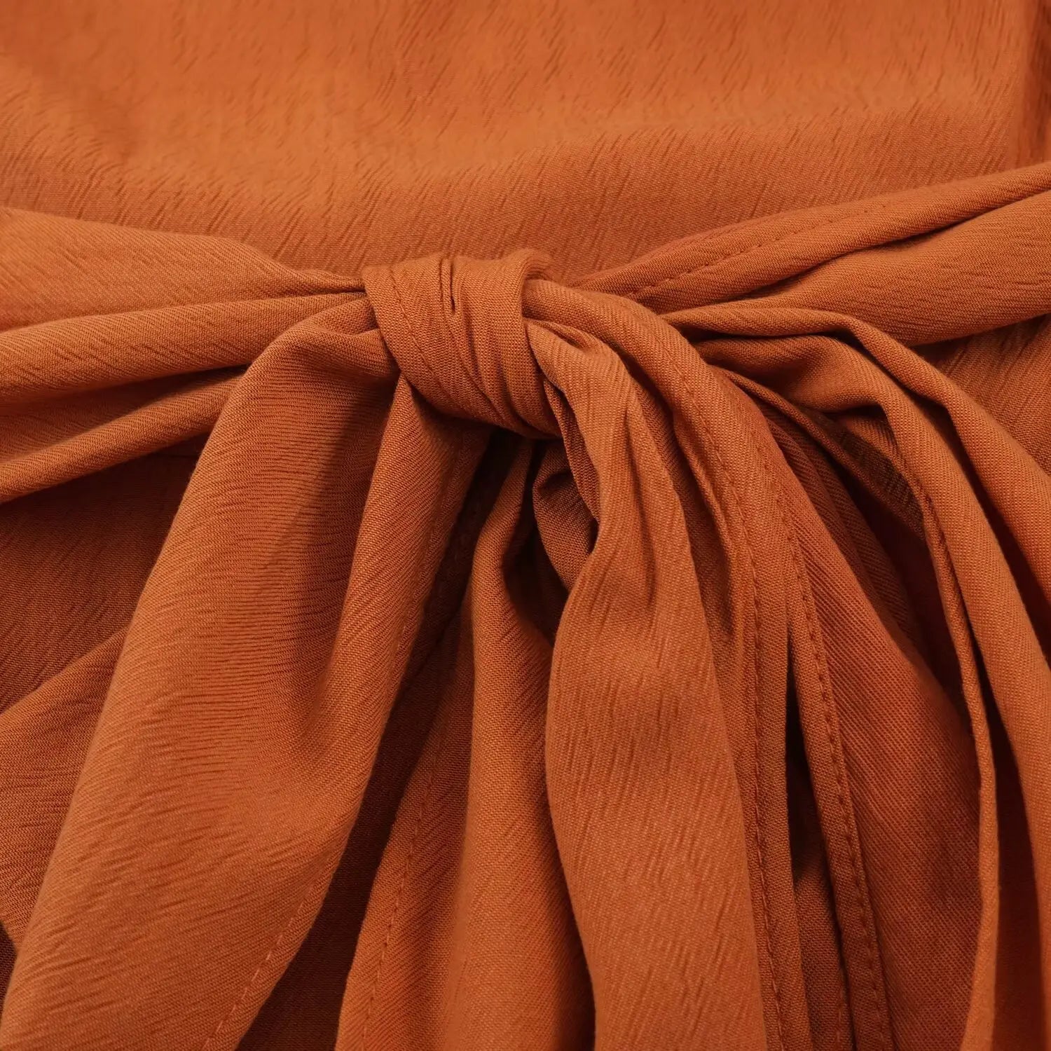 Self fabric waist tie bow close-up, adjustable wrap belt for rust cowl neck sleeveless romper