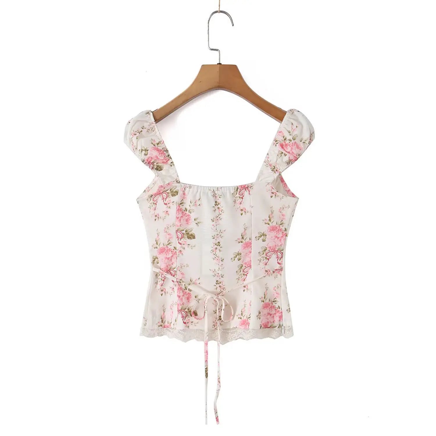 Back view of the rose print square-neck top hanging on a wooden hanger, showing the lace hem and back tie