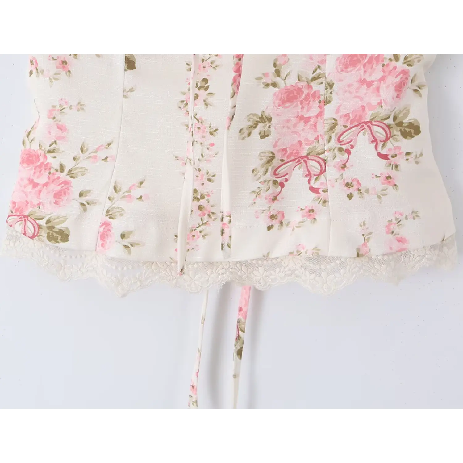 Close-up shot of the rose print square-neck top's lace hem and floral pattern