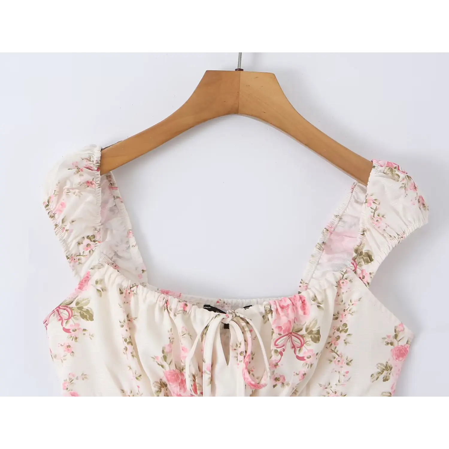 Close-up shot of the rose print square-neck top, showing the square neckline and front tie detail