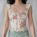 Lifestyle shot of a woman wearing the rose print square-neck top, paired with a light green skirt