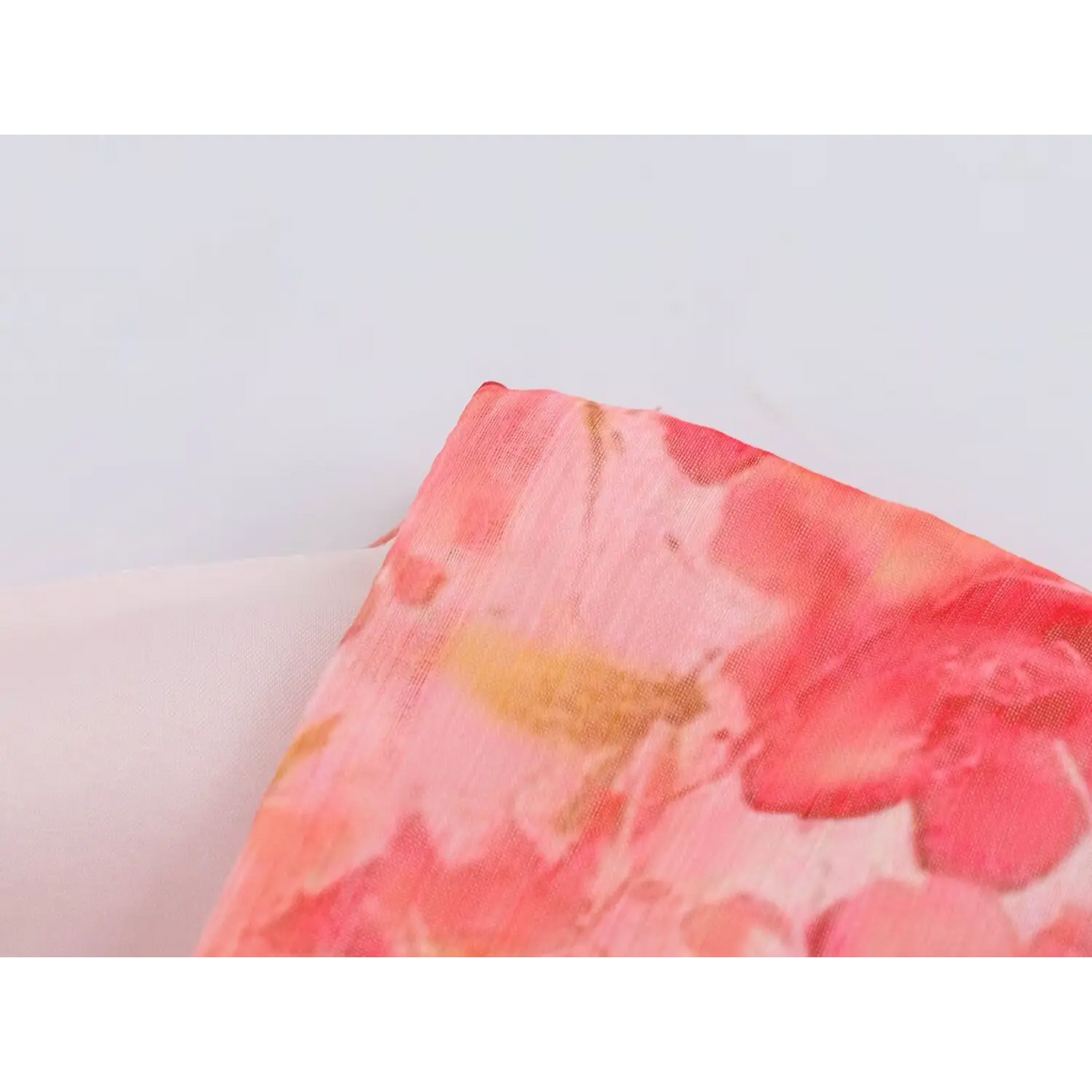 Close-up of buttoned cuff on rose print dress