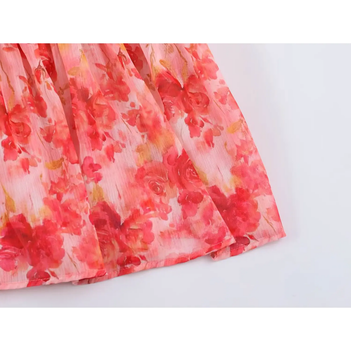 Close-up of finished hem on rose print ruffle dress