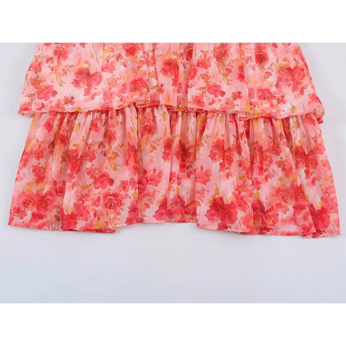 Close-up of tiered ruffle skirt on rose print dress