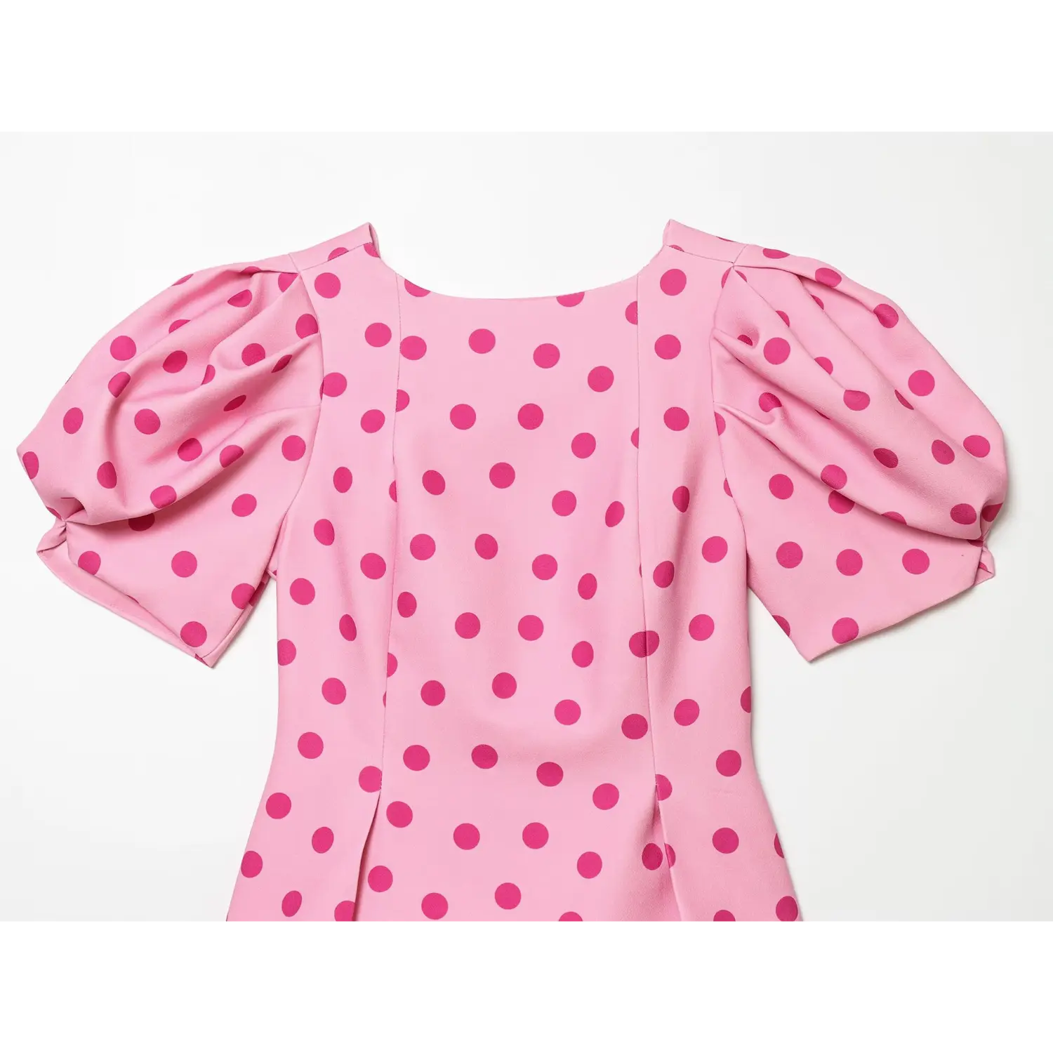 Full back flat shot showing back round neck, sleeve gathering, vertical dart seams