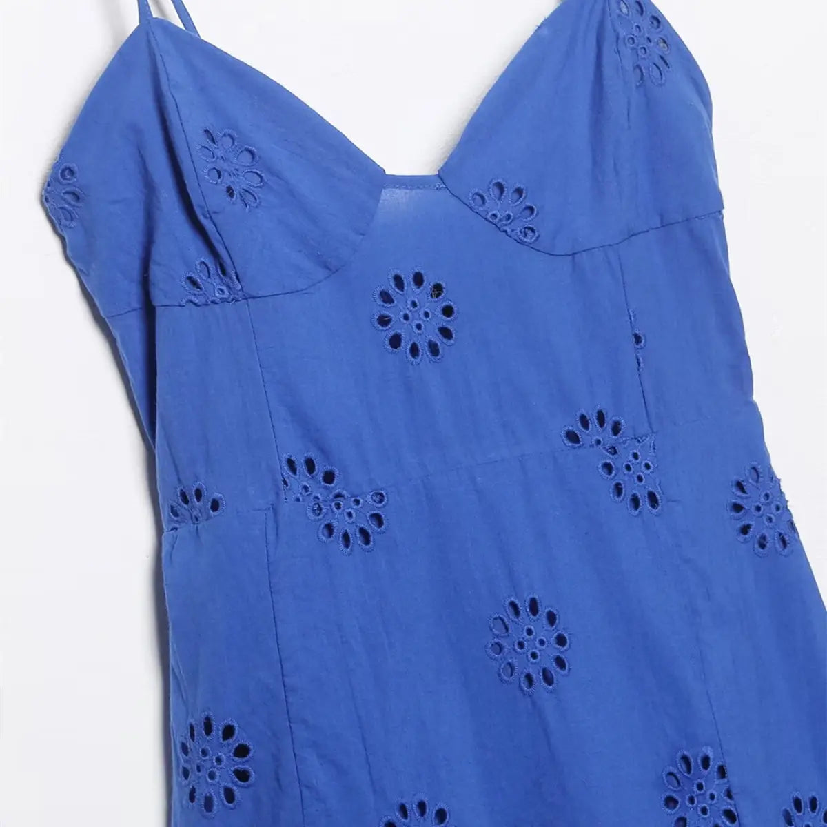 Bodice view of royal blue eyelet ruffle dress, showing the V-neckline, spaghetti straps, and all-over floral eyelet embroidery