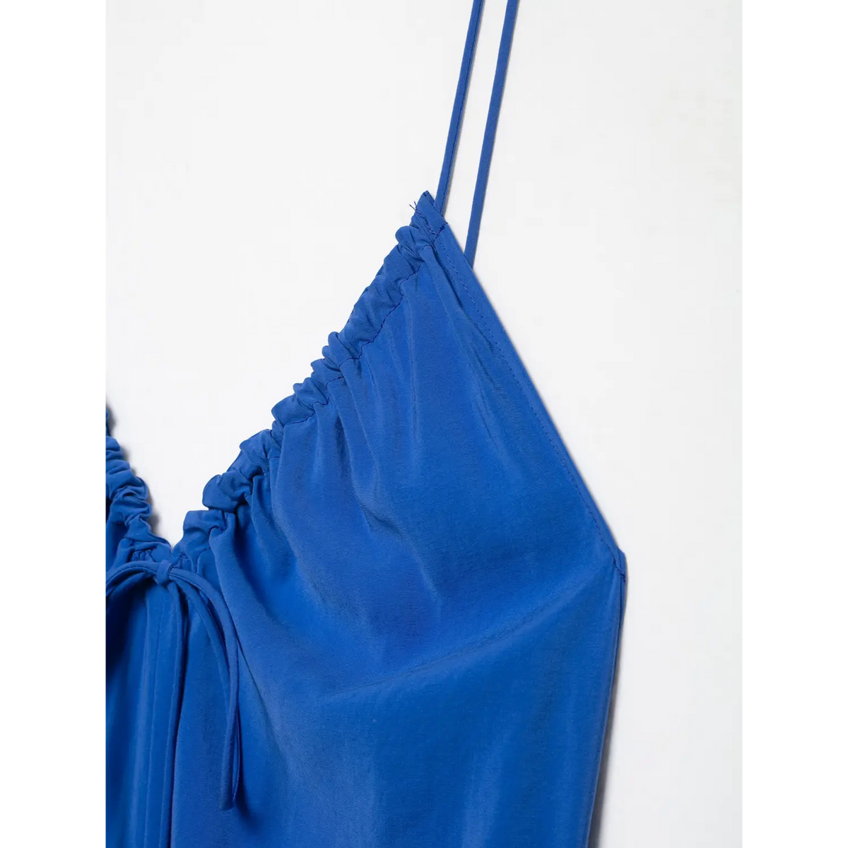 Close‑up of gathered shoulder and neckline fabric