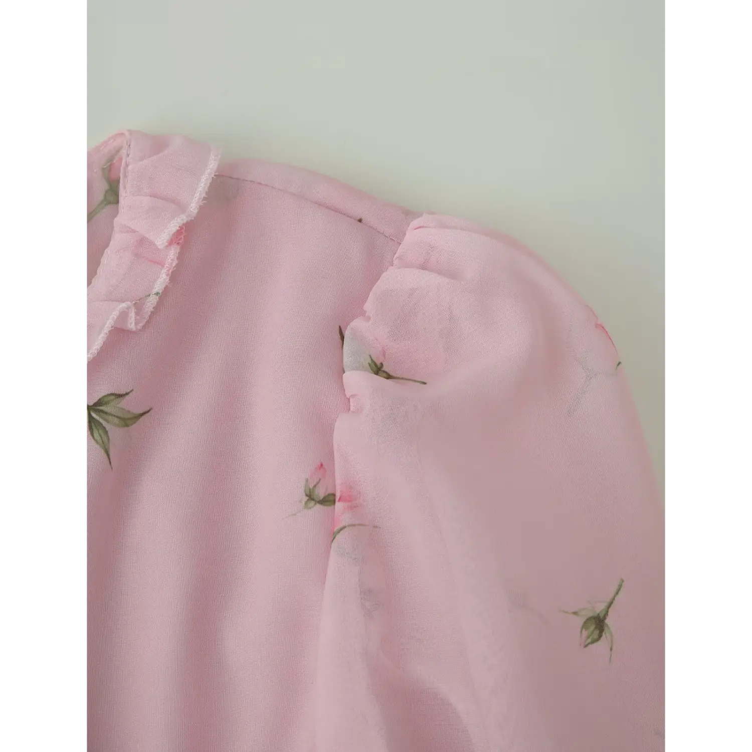 Front keyhole neck macro close-up, layered cascading chiffon ruffle trim, tiny rose bud printed fabric