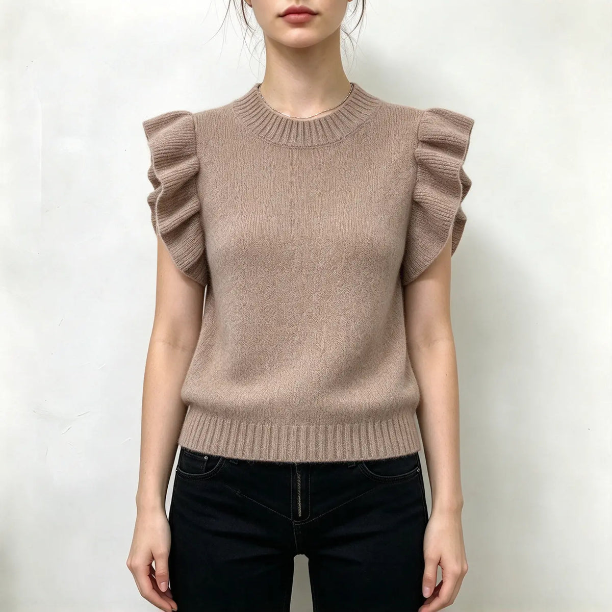 Model wearing oatmeal ruffle shoulder mock neck knit top, front view