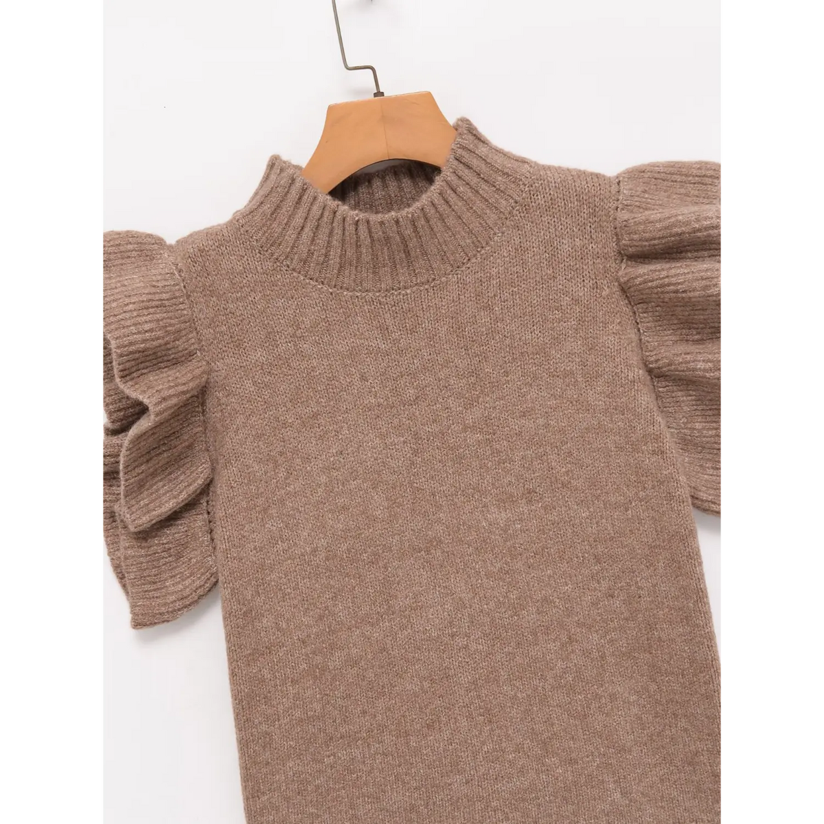 Close-up of oatmeal ribbed mock neck and ruffle shoulder